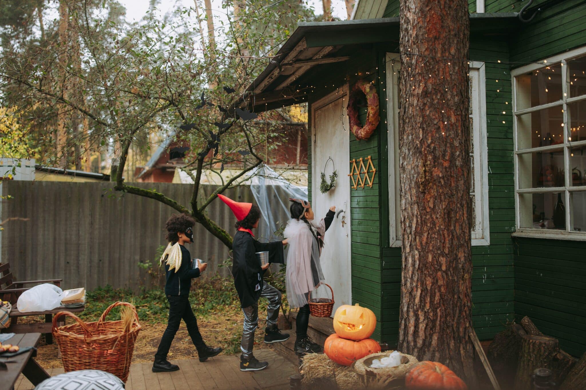 A group of kids trick-or-treating on Halloween.