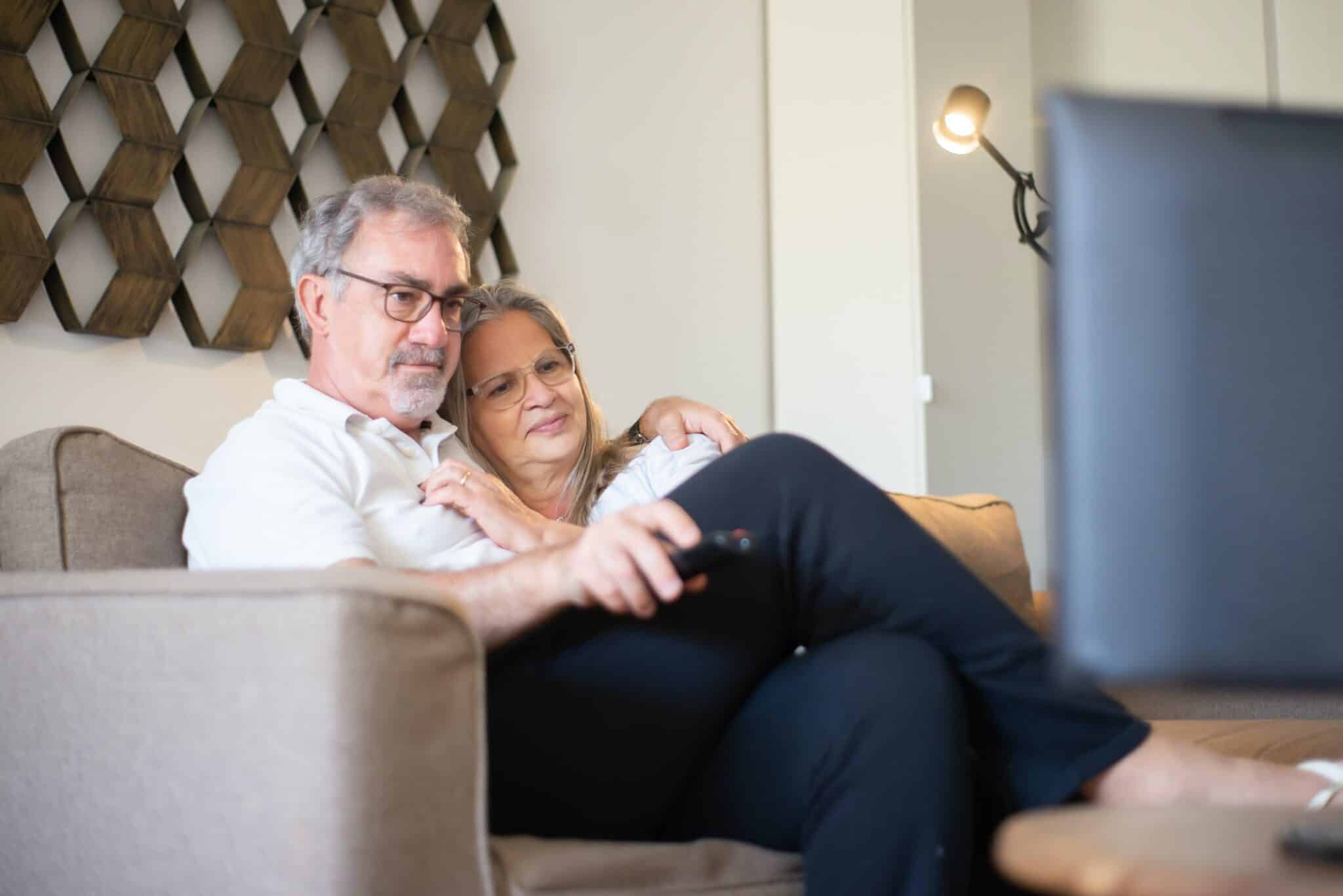 Older couple watching TV together.