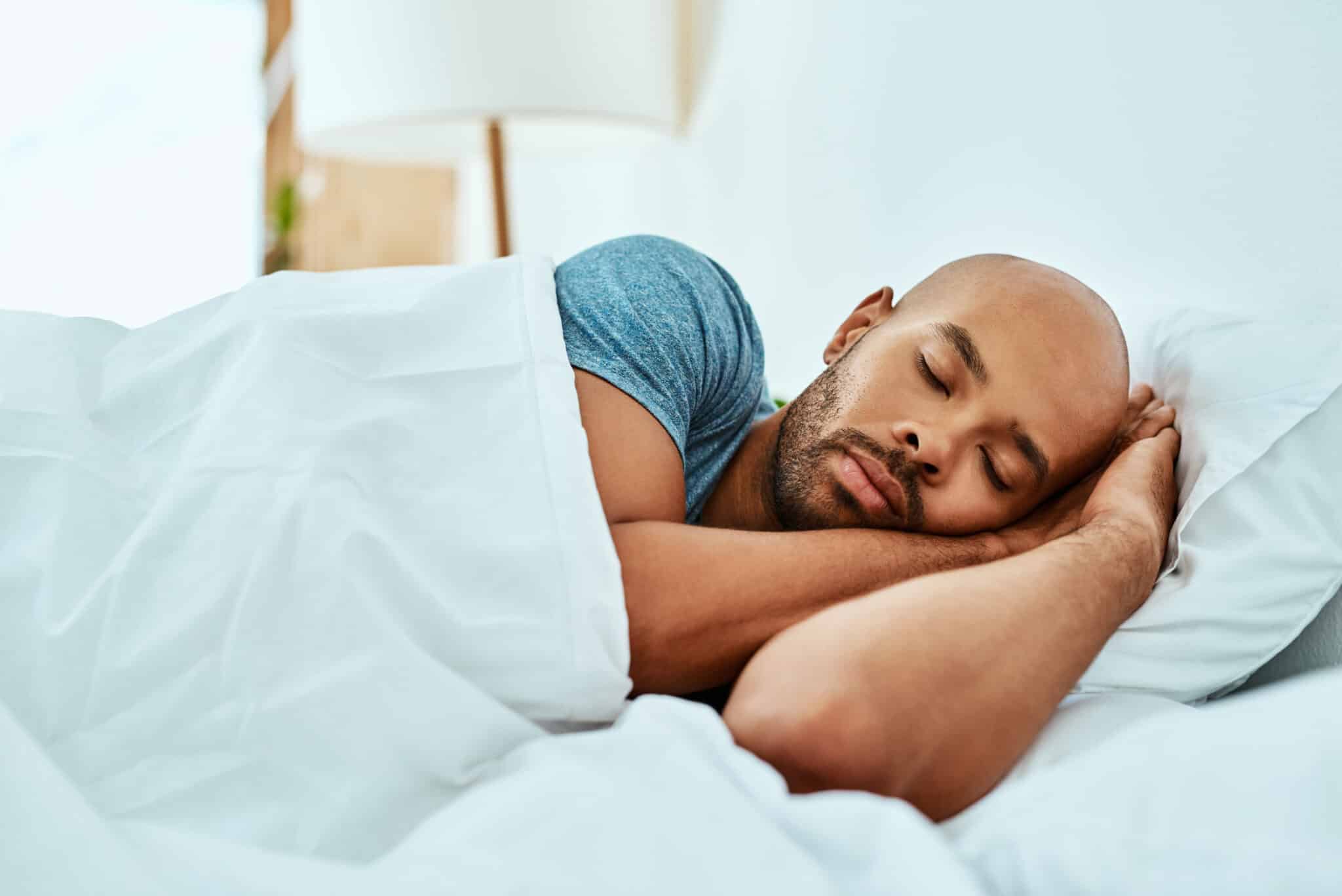 Man peacefully sleeping in bed.
