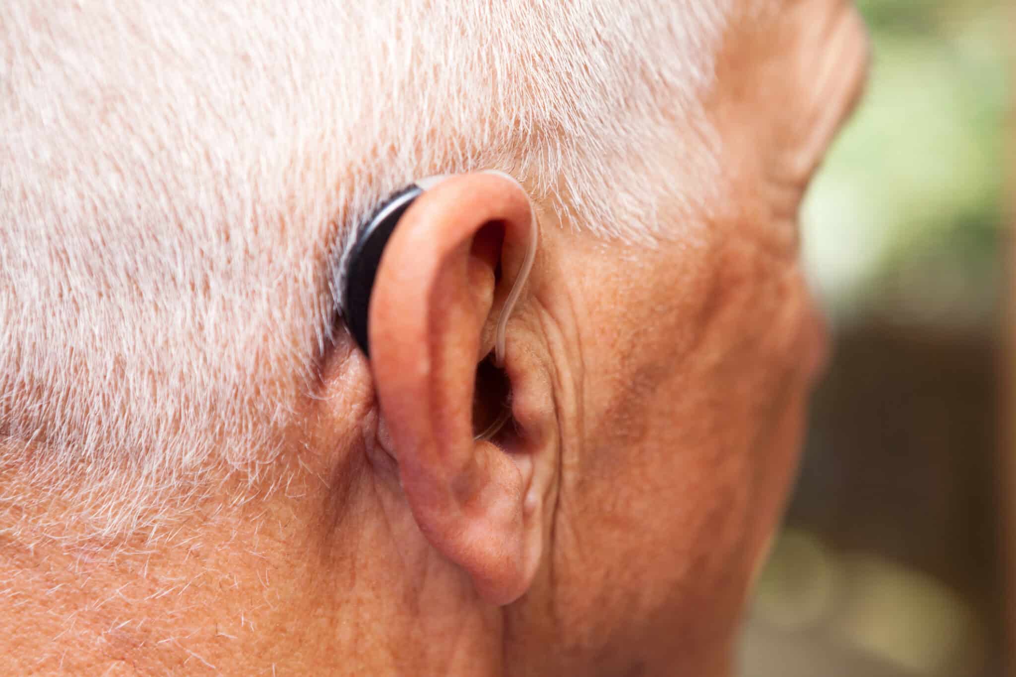 Senior man wearing a behind-the-ear hearing aid.