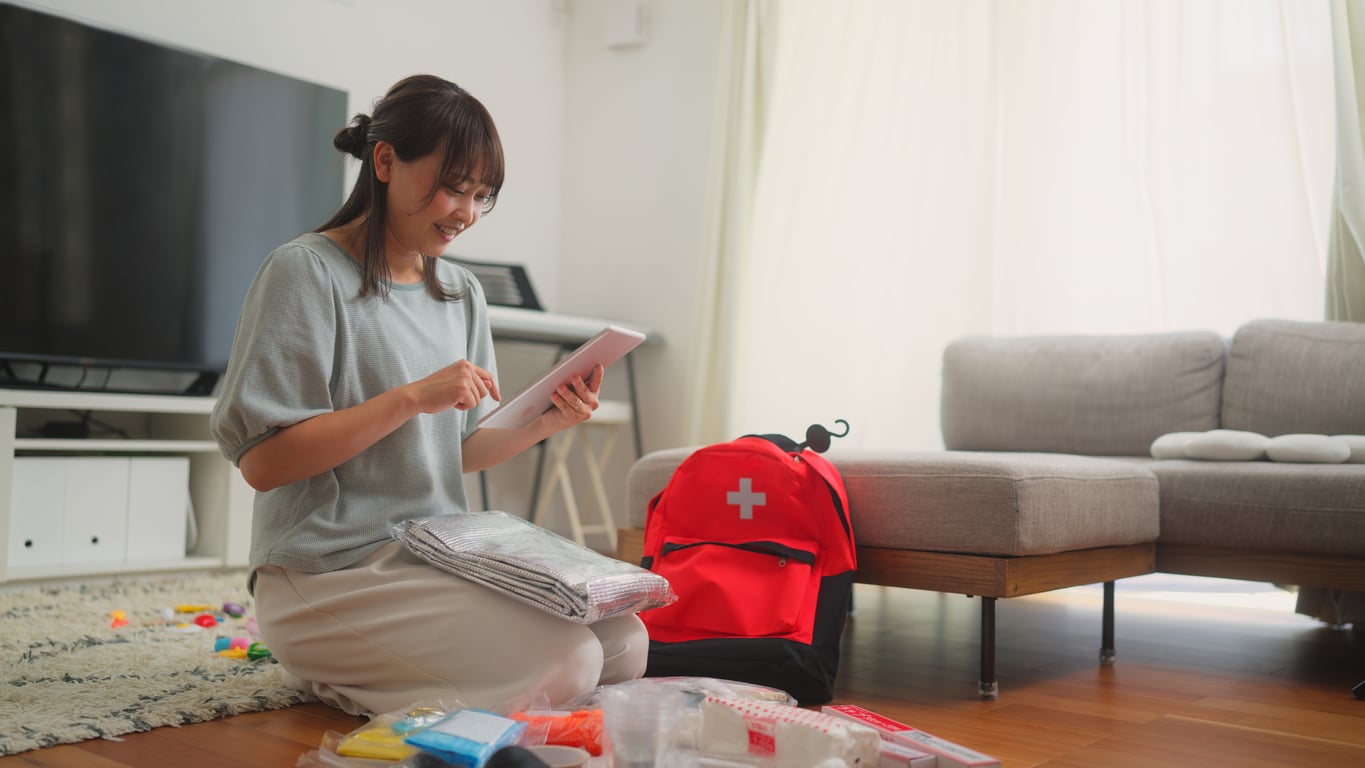 Woman preparing an emergency kit at home.